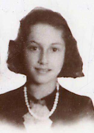Vintage black and white portrait of a smiling woman wearing a pearl necklace.