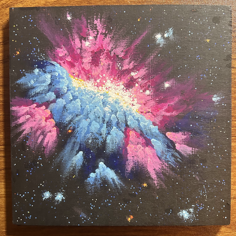 Pink and blue space nebula filled with bright white stars on a black starfield