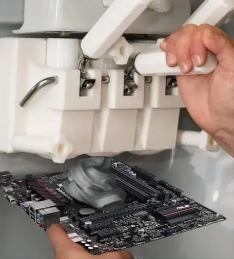A person using an ice cream dispenser but instead of ice cream it dispenses a copious amount of thermal paste onto a CPU.