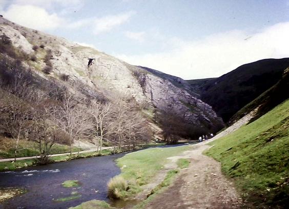 A serene, steep-sided valley, with white rock (limestone) exposed