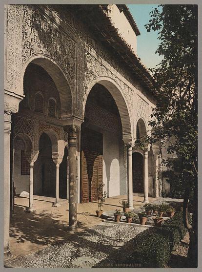 The image showcases an intricate and beautifully designed architectural structure known as the Generalife, located in Granada, Spain. The photograph captures a section of the building with detailed arched doorways that are adorned with ornate carvings and patterns, indicative of Islamic or Moorish architecture.

Several columns support these arches, adding to the overall grandeur of the scene. In front of the structure is an expansive courtyard paved with stones, upon which one can see potted plants placed strategically around it, possibly for decoration or practical purposes like providing shade.

The sunlight casts shadows on the ground, creating a contrast between light and dark areas that highlight the texture of both the architecture and natural elements within the space. The overall atmosphere is serene and evocative of historical Islamic civilization's architectural prowess.

Additional information about this image can be found in Granada at Galeria exterior del Generalife Zürich, Switzerland by Photoglob Company, dated around 1890-1906. This print likely represents a part of the region’s rich cultural heritage and serves as an artistic record for future generations to appreciate its architectural beauty and historical significance.

The URL provided in the alt text is not currently active or associated with this specific image; it's included here solely for contextual purposes, suggesting that further information [...]