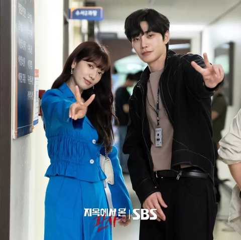 Park Shin Hye, in a fashionable blue suit & Kim Jae Young, in a casual outfit, making V signs with their hands for a pose from the 2024 South Korean Drama "The Judge from Hell."