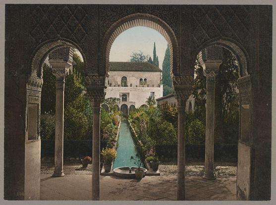 This image features an ornate courtyard with a central pool, bordered by tall arcades and lush greenery. The architecture showcases intricate patterns on the arches and columns, indicative of Moorish design commonly found in Islamic-influenced Spanish palaces like Alhambra or Generalife in Granada, Spain.

The photograph has a vintage feel, suggesting it was taken around late 19th to early 20th century. It captures an intimate view through the arches with ample daylight illuminating the courtyard's details. The perspective is from within the structure looking outwards towards the pool and beyond into another building in the distance.

This specific image appears as part of a collection by Photoglob Company, based on its date range (ca. 1890-1906), which was likely used for commercial or educational purposes during that period. It's important to note this context when interpreting historical architectural and cultural references within such photographs.