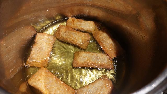 Egg rolls cooking in oil