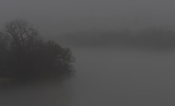 In image #2, dense fog covering the James River at Rocketts Landing in Richmond VA USA. In the left foreground is one bank of the river lightly shrouded by fog. In the background is the other bank of the river barely visible through the fog. Processed in ON1 Photo RAW 2025.