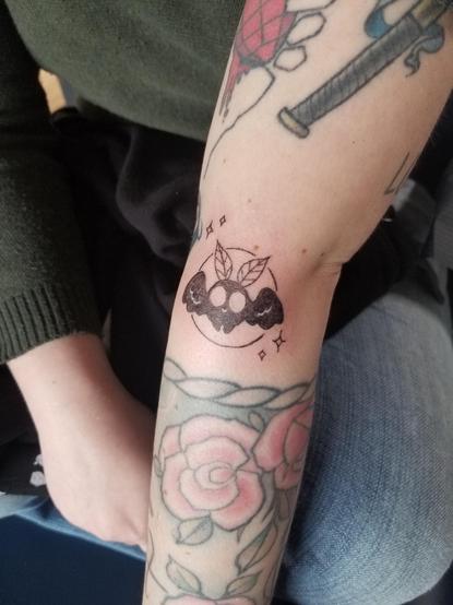 A mini mothman tattoo