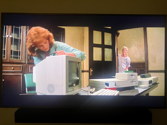 A human setting up an Amiga 1000 computer
