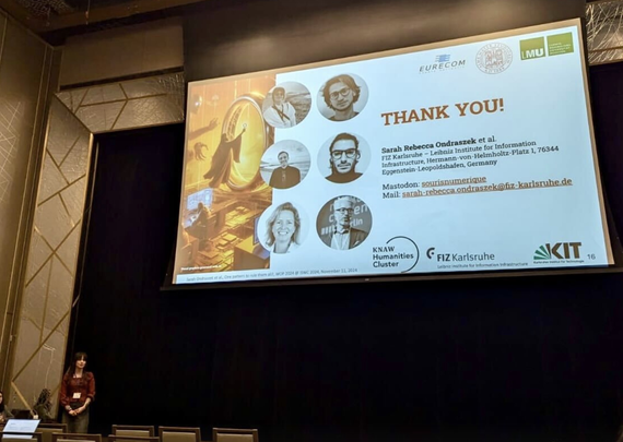Sarah Rebecca Ondraszek (lower left corner) at the end of her presentation during WOP 2024 workshop at ISWC 2024 in Baltimore, USA. The big screen above her head is showing the "Thank You" slide with contact information and pictures of all co-authors.