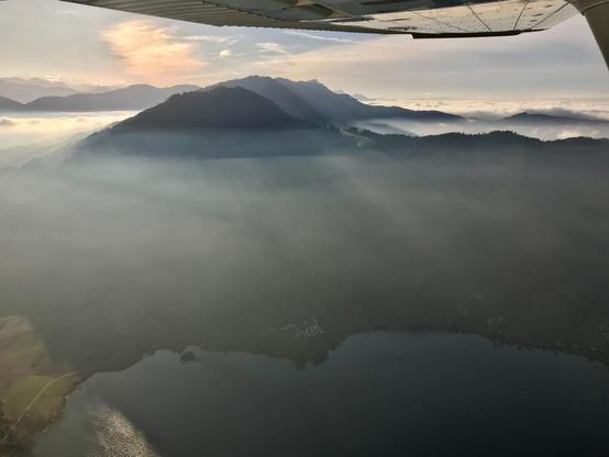 Sunrays in the fog, view from the airplane.