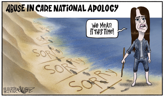 Title: Abuse in Care National Apology  Erica Stanford stands barefoot on a well trodden beach. Many sorry's are scattered throughout the beach with a line under them. Her footsteps are all over the apologies. And then she turns to the camera and says, "We mean it this time!"