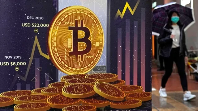 FILE – An advertisement for Bitcoin cryptocurrency is displayed on a street in Hong Kong on Feb. 17, 2022. (AP Photo/Kin Cheung, File)