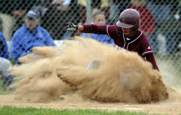 5/26/2009 Mike Orazzi | Staff
Bristol Central's Taylor Plantamuro (12) slides safely at home during Tuesday's match up with Eastern.