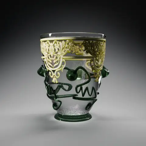 View of the modelled ornate beaker: a transparent glass tumbler with a green foot and four sinuous prunts. A centimetre under the rim, all around the circumference, is an ornate white and yellow decor of mascarons and simplified leaves.