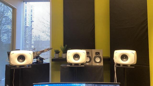 Room view of front speakers of a 5.1 surround set, using Genelec active monitors. Acoustic paneling & Lego Star Wars X-Wing on the background.