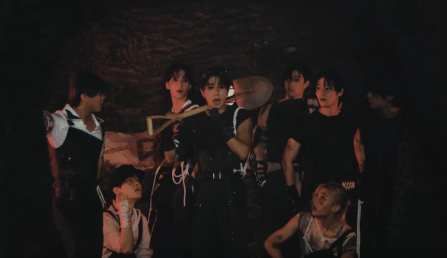 tiny miners skz surround Han in a tunnel underground. He has just sneezed and they all look at him in alarm