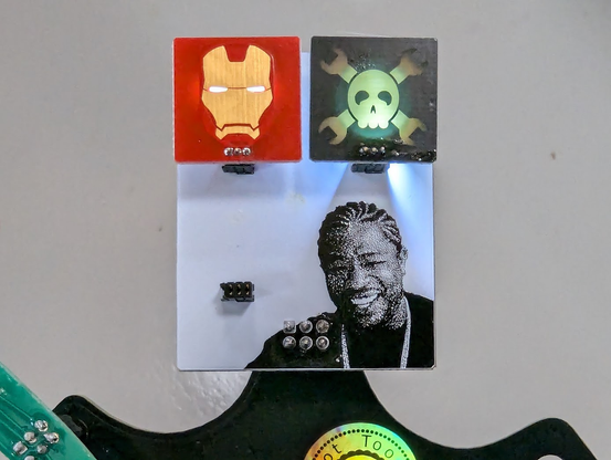 A badge SAO that allows you to put even tinier SAOs onto your SAO. In this case, a tiny Iron Man badge and a tiny Hackaday logo badge, both backlit with LEDs