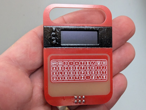A circuit board in the shape of the classic 80's toy the Speak and Spell