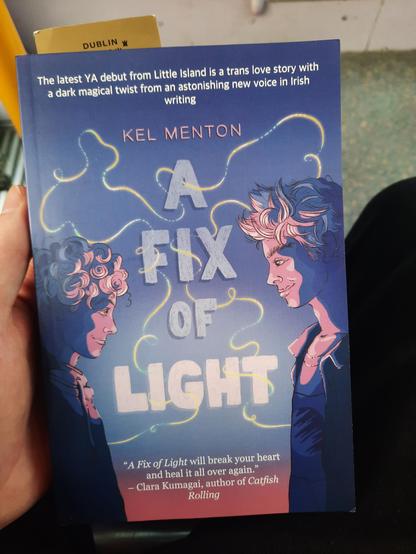 A Fix of Light by Kel Menton. Purple and pink cover featuring two boys, the protagonists of the story.