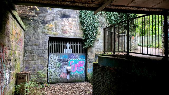 The sealed up entrance to an abandoned railway tunnel beneath a popular Glasgoe park.