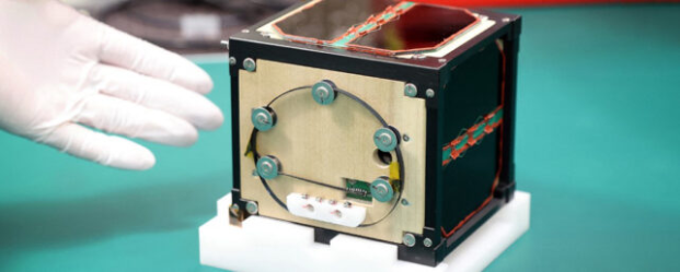 [ImageSource: Japan Aerospace Exploration Agency (JAXA)]

The satellite is made with honoki, a magnolia tree native to Japan whose wood was historically used to craft samurai sword sheaths.

LignoSat is a 10 cm cubesat made mainly of wood and solar panels and a smattering of electronics to record how the satellite holds up during its six months in orbit. Data collected will include temperature, the expansion and contraction of the wood as the spacecraft orbits, geomagnetism and hardware performance onboard. One hope is that the use of wood will reduce the impact of space radiation on electronics.

The origins of LignoSat (named after the Latin word for wood, “lignum”) date back to 2017, and come from former NASA astronaut and engineer, Takao Doi. At the time, Doi wondered if future human explorers on the moon and Mars could one day turn to materials other than steel and concrete to construct safe, resilient buildings.