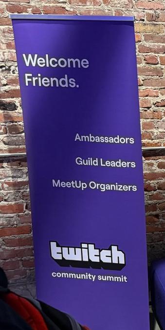 A picture of a sign in Twitch's HQ that says "Welcome Friends. Ambassadors. Guild Leaders. Meetup Organizers" for Twitch's Community Summit.