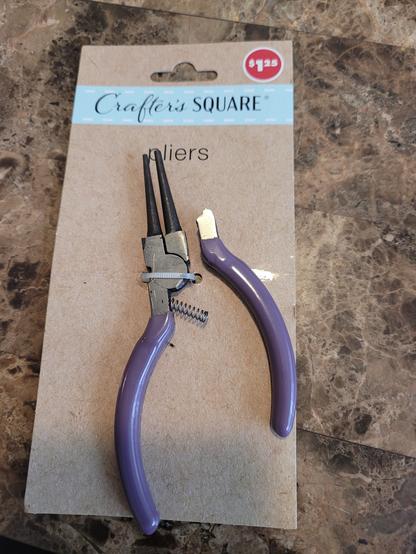 Pliers from the Dollar Tree ($1.25 Crafyer's Square Brand).

The pliers are still in the packaging and the right sid eof the handle is seen snapped in half. This is cast metal too.

All i did was grab it in preparations for the scissors in my left hand