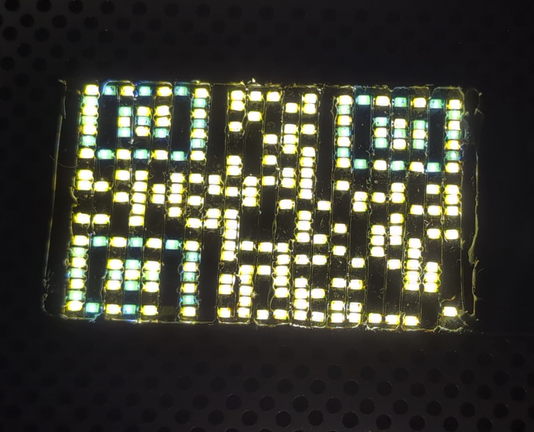 A QR code made with 1206 LEDs hand soldered to metal bars.