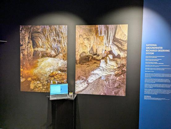 Photo exhibit of a mine and a cave, with computer downloading a logger in foreground