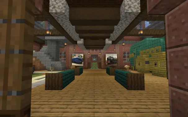 a look into an exhibit of older trains with a photo of the A1 Peppercorn on the right and another blue train on the left, its lined with benches and a slight view of a green train is vissible