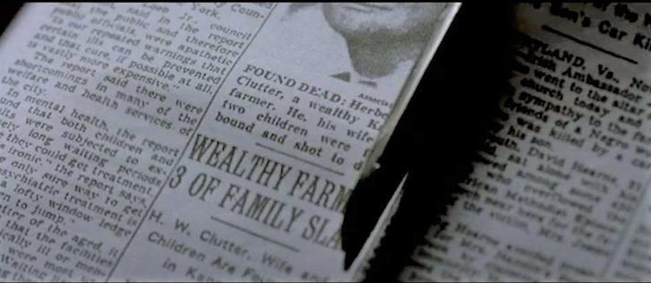 Scissors clipping out a newspaper item, with the headline “wealthy farm, 3 of family slain”