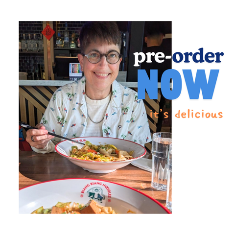 This is a picture of me, Annalee, in a white shirt covered in parrots, and I'm eating biang biang noodles at a restaurant. I am smiling and holding chopsticks. The text reads: "Pre-order now -- it's delicious."