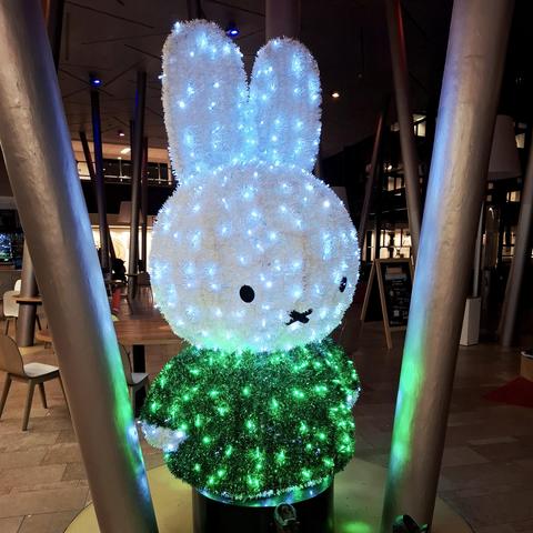 Illuminated green and white Nijntje aka Miffy statue at the WKZ Wilhelmina Kinderziekenhuis in Utrecht.