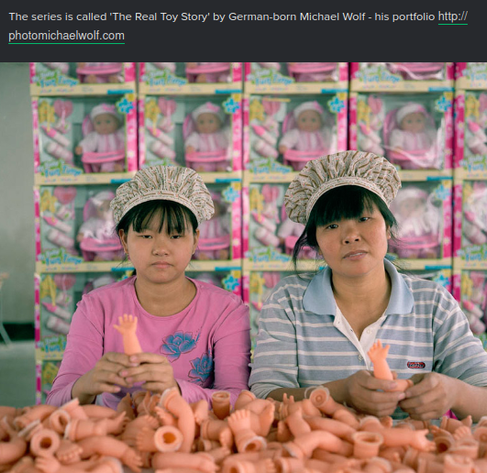 A screenshot from the second link (imgur) in the post. The text "This series [of photos] is call 'The Real Toy Story' by German-born Michael Wolf..." is above a photo of two young women seated before stacked packages of toys, baby dolls seen through the packaging. The the women are seated behind a work table covered with toy baby-doll arms and each old one arm up with the little baby hand facing the camera. The workers are wearing hairnets (cloths?) and a simple shirt or poloshirt each.. The packaging is very pink as is the simple shirt on the younger woman.