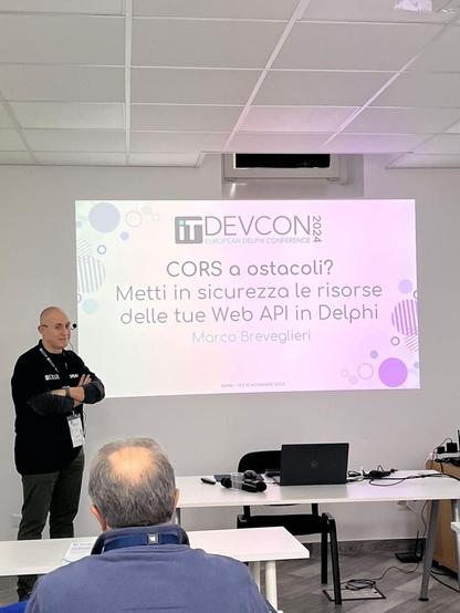 Photo of me and the title of my session about CORS