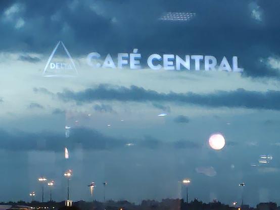 View at Lisbon Airport, out to runway, reflected sign of Cafe Central