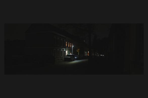 Trying a new style for nightshots. Does this work out on Mastodon, for your devices?

Edited color wide angle photo through a slight mist filter, cropped to 2.7x1 inside a dark grey frame filling the picture to 3x2.

A dimly lit urban street at night. All lights have slight halation to it. The scene featuring a row of buildings with a few warmly lit windows and cars parked along the street. A streetlamp emits a cooler glow, casting a soft, bluish light onto the road and a nearby tree, contrasting with the warmer tones of the illuminated windows. The surrounding area remains shrouded in darkness. (Photo by user, CC-BY-4.0)