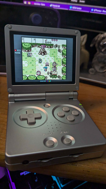 The game being displayed on the screen is The Legend of Zelda: Oracle of Seasons for the Gameboy Color.