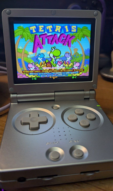 The game being displayed on the screen is Tetris Attack for the Super Nintendo.