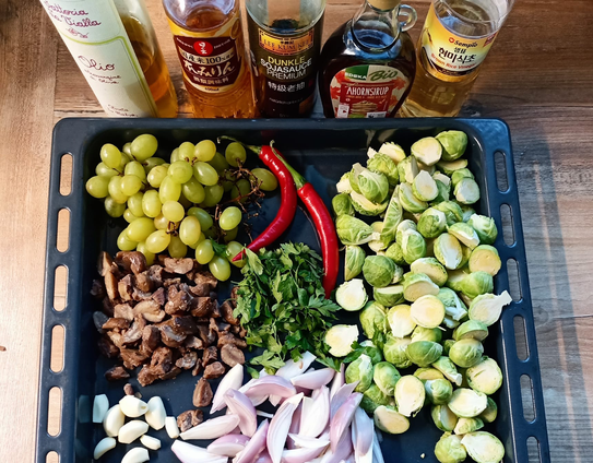 Das Gemüse vor dem Kochen auf einem hohen Blech, dahinter stehen alle flüssigen Zutaten.