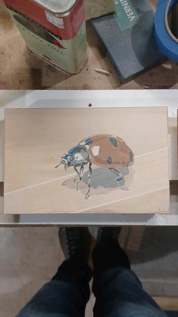 wood veneer marquetry image of a shiny ladybug