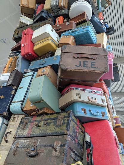 Image caption: Public art brings the mundane to life: 

Image displays stacked-high suitcase sculptures in the bag claim area at Sacramento International Airport.