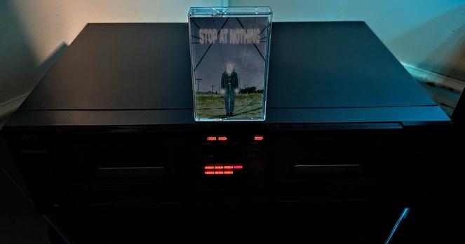 Cassette of Sea Lemon's Stop at Nothing EP sitting atop black JVC dual cassette deck player.