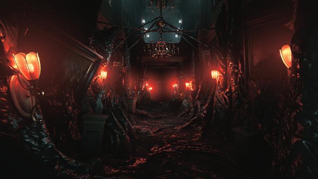 Ein düsterer Gang im Halbdunkel mit sehr hoher Decke. Irgendeine undefinierbare Masse hat die Wände teilweise überzogen, Leuchten an den Seiten tauchen die Szenerie notdürftig in rotes Licht.