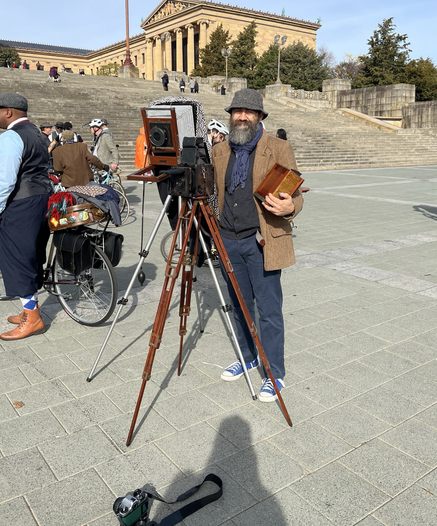 A cell phone photo of me posing with my gear (3 large format cameras). In front of the museum.