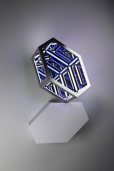 Geometric light sculpture with blue and white illuminated lines, casting a shadow on a grey background.