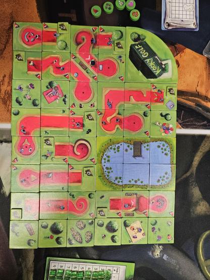 My minigolf course, Kooky Golf. Nine small, but tricky holes. A lake sits nestled between them with a cute little pier. Happy golfers run around the course enjoying their day at the third best minigolf course at the table.