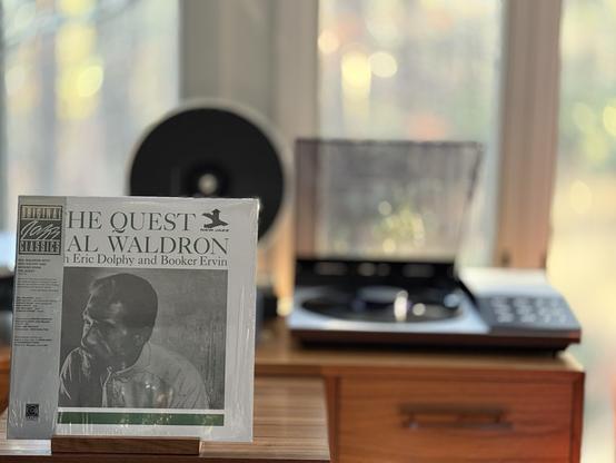 Mal Waldron - The Quest LP cover.

White bordered black and white photo of Waldron looking to the left.

The black LP plays on a vintage, restored Bang & Olufsen Beogram 8002 linear-tracking turntable to the right.