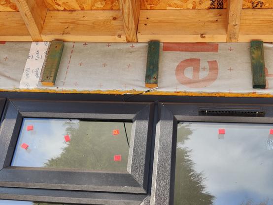 front window of the office with probe sticking out of a window gap