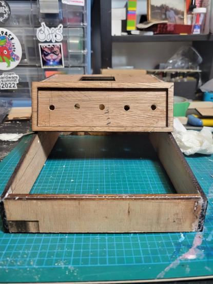 The front view of the shell displaying the drilled holes mounted to the front after the keyboard area. A front is glued in to enclosed the box.
