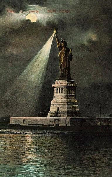 Moonlight view of the statute. Her touch is sending light below.